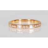 A good 18k yellow gold ladies ring set with seven square and round cut diamonds of approx 30pts.