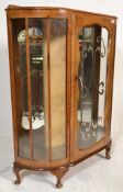 A 1940's walnut Queen Anne demi lune china display cabinet vitrine raised cabriole legs with pad