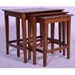 A vintage 20th Century nest of three table having rectangular tops raised on tapering block legs