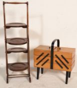 A vintage early 20th Century mahogany four tier cake stand having rounded metamorphic fold down