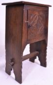 A mid century Ipswich oak Arts & Crafts pot cupboard. Raised on panel sides with pierced arch