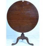 An 18th century mahogany bird cage / tilt top wine table. Raised on tripod base with splayed hoof