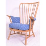 A vintage retro 20th Century Ercol beech wood spindle back armchair having turned splayed legs