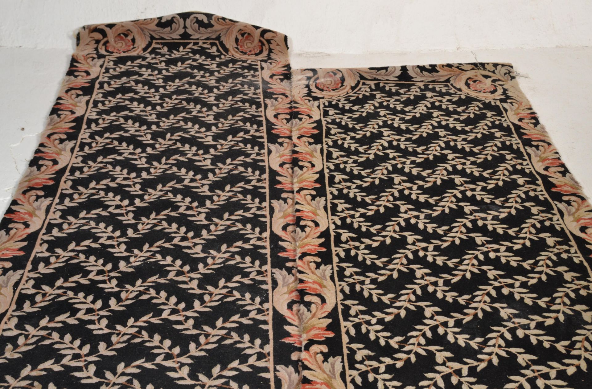 A matching pair of vintage 20th Century floor rug runners having black ground with cream floral - Image 5 of 5