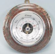 A late 20th Century Shortland wall barometer of round form having a silvered dial with black