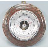 A late 20th Century Shortland wall barometer of round form having a silvered dial with black