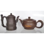 A pair of 20th century Chinese Yi Xing terracotta teapots. One of the teapots has a bamboo design on