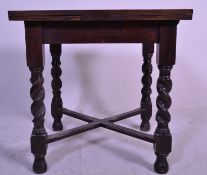 An early 20th Century oak drawer leaf dining table of good small proportions raised on barley