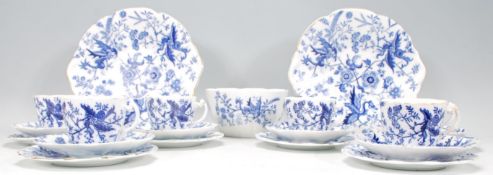 An early 20th Century flow blue / blue and white part tea service decorated with floral and dragon