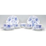 An early 20th Century flow blue / blue and white part tea service decorated with floral and dragon