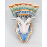 A 20th Century Majolica wall mounting bracket in the form of a bulls head above a shaped base with