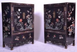 A pair of Chinese 20th century black lacquer side cabinets. Each with black grounds with chinoiserie
