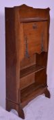 A VIctorian 19th century Arts & Crafts oak student bureau having stepped feet with open bookcase