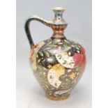 An early 20th Century Hungarian Arts and Crafts jug of tapering bulbous form having a curved