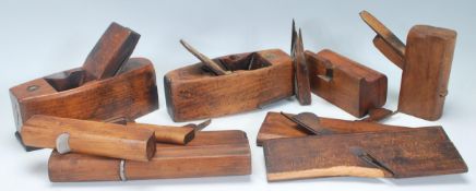 A collection of early 20th Century woodworking tools / wood planes of varying sizes to include H.