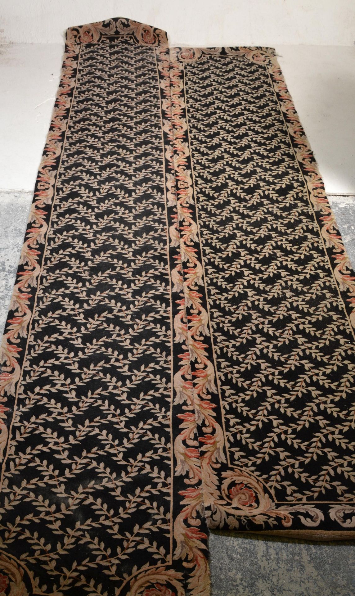 A matching pair of vintage 20th Century floor rug runners having black ground with cream floral - Image 2 of 5