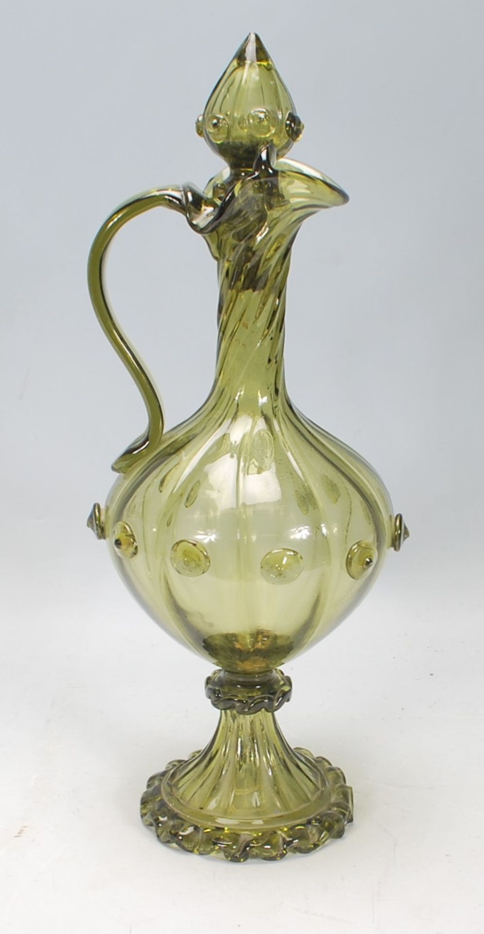 A 20th Century Murano green glass ewer jug having a reeded bulbous form body with a twisted neck,