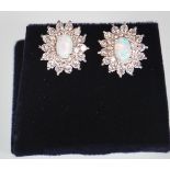 A pair of ladies stamped 925 silver stud earrings. Cubic Zirconia are set in a double halo design,