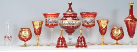 A collection of vintage red / ruby Bohemian glass style vessels to include a lidded vase of