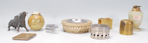 A collection of vintage table lighters to include an alabaster lighter with gilt striker to the top,