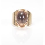 A hallmarked 9ct gold 1970's ladies dress ring set with a brown cabochon stone. Hallmarked