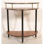 A retro 20th Century three tier demi lune hall table raised on three ebonised supports with brass