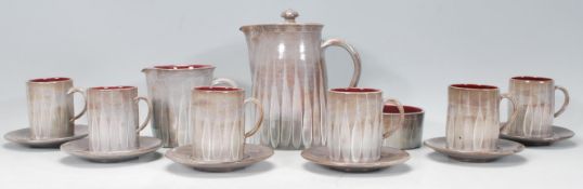 A vintage 20th Century Cornish studio art pottery coffee service to include six coffee cans having a