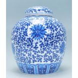 A Chinese large lidded ginger jar of bulbous form being hand painted in blue and white in the