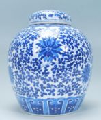 A Chinese large lidded ginger jar of bulbous form being hand painted in blue and white in the