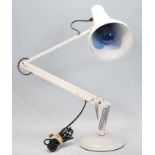 A vintage 20th Century anglepoise desk lamp raised on a round base with pendant lamp shade to top,