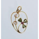 A 20th Century stamped 15ct gold open work pendant set with seed pearls, peridots and a ruby