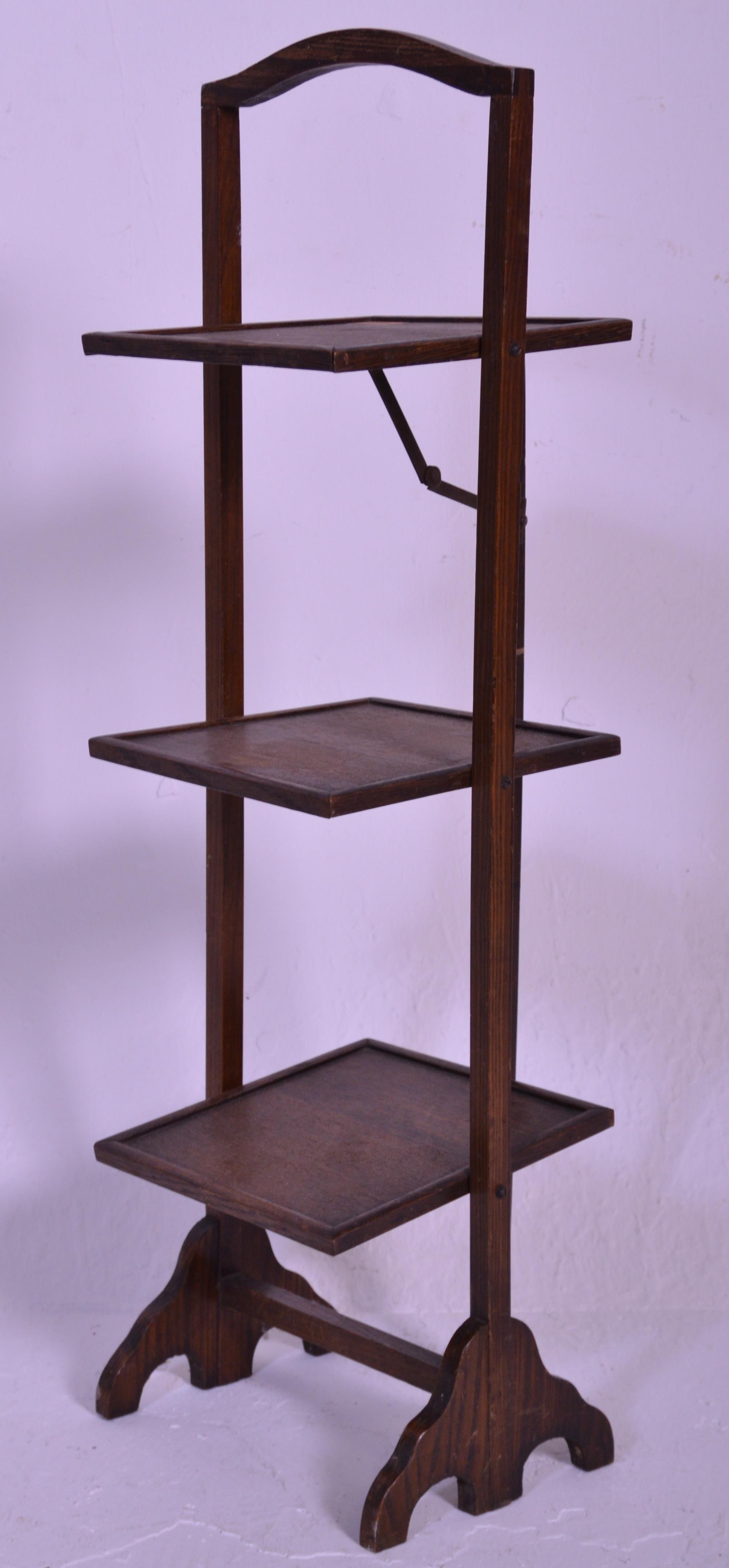 A vintage early 20th Century 1930's oak three tier folding cake stand of square form raised on
