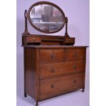 A early 20th Century 1920's Art Deco oak dressing table chest of drawers having an oval swing