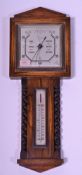 A mid 20th Century oak cased banjo wall barometer having thermometer above flanked by barley twist