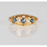 An early 20th Century 18ct gold ring set with three round cut sapphires and two round cut diamonds