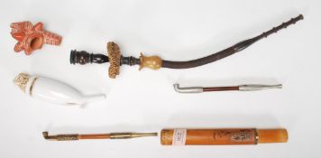 A collection of vintage pipes to include two Opium pipes one in a bamboo carry case, South