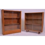 Two 20th Century freestanding closed bookshelves each having glass sliding doors with two shelves