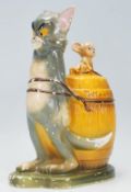 A vintage retro 20th Century 1972 Tom and Jerry money box depicting Tom strapped to a barrel with