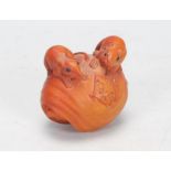 A Japanese carved wood Netsuke toggle in the form of two rats perched on a sea shell with a third