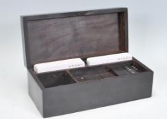 An early 20th Century ebonised mahogany games box of rectangular form inlaid with silver white metal