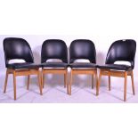 A good set of four retro 20th Century black covered rexine dining chairs of shaped form raised on