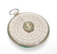 A vintage Halden Calculex circular slide rule with suspension loop to the top, set within a