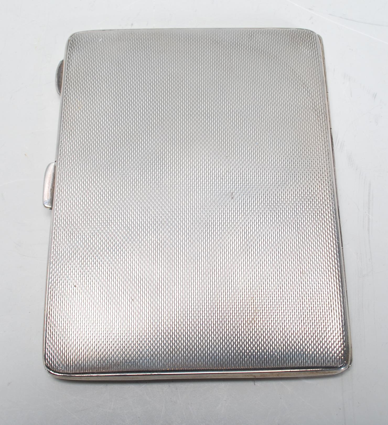 A vintage 20th Century English silver hallmarked cigarette case of rectangular form having engine - Image 3 of 7