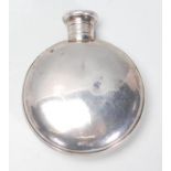 A good early 20th Century silver hallmarked moon flask / hip flask having a screw top. Hallmarked