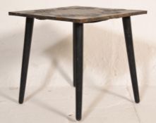 A 20th Century side table having a square metal cased tale top having repousse decoration of Art