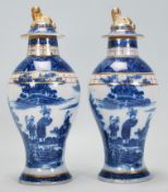 Two early 19th Century blue and white pearlware lidded baluster vases having transfer printed