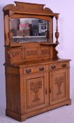 A Victorian Art Nouveau light oak mirror back sideboard credenza having a raised arched back with