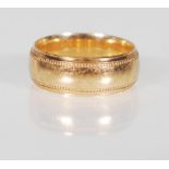 A 9ct gold wedding band ring having beaded decoration to the edges. Marked 375, makers mark PHW.