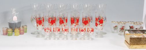 A mixed collection of vintage retro 20th Century drinking glasses of various sizes to include a