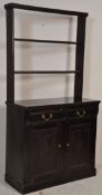 An Edwardian early 20th Century ebonised dresser having twin panelled doors to the base with two